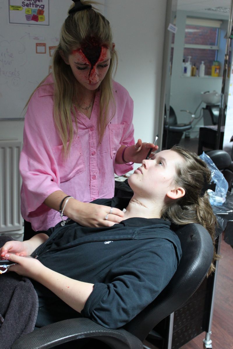 Student applying Halloween make-up 