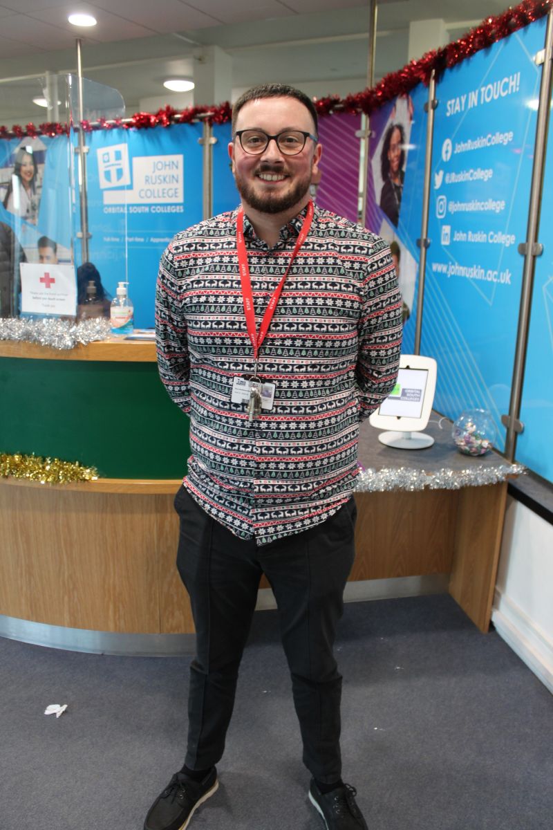 A member of staff in a Christmas jumper
