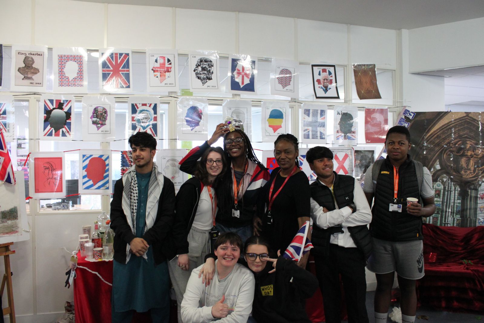 Group of students with coronation art display behind them
