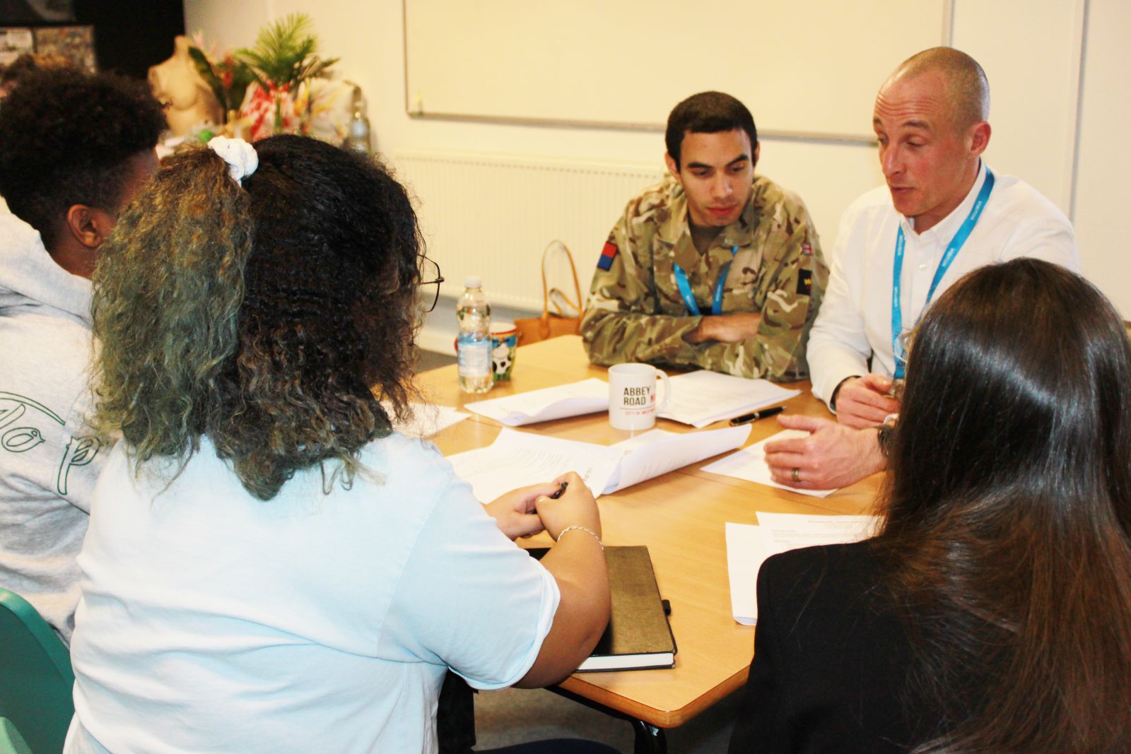 Creative art students talking to army representatives