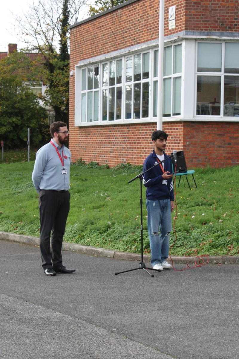 The Student Union Vice President Talha standing at a microphone outside the College