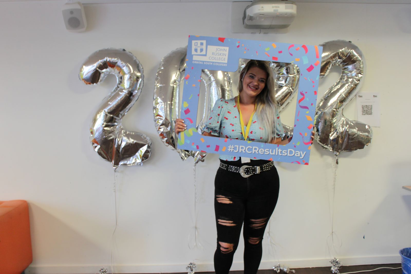Student holding selfie frame to celebrate results day